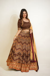 Woman wearing a patterned traditional outfit with a plain background