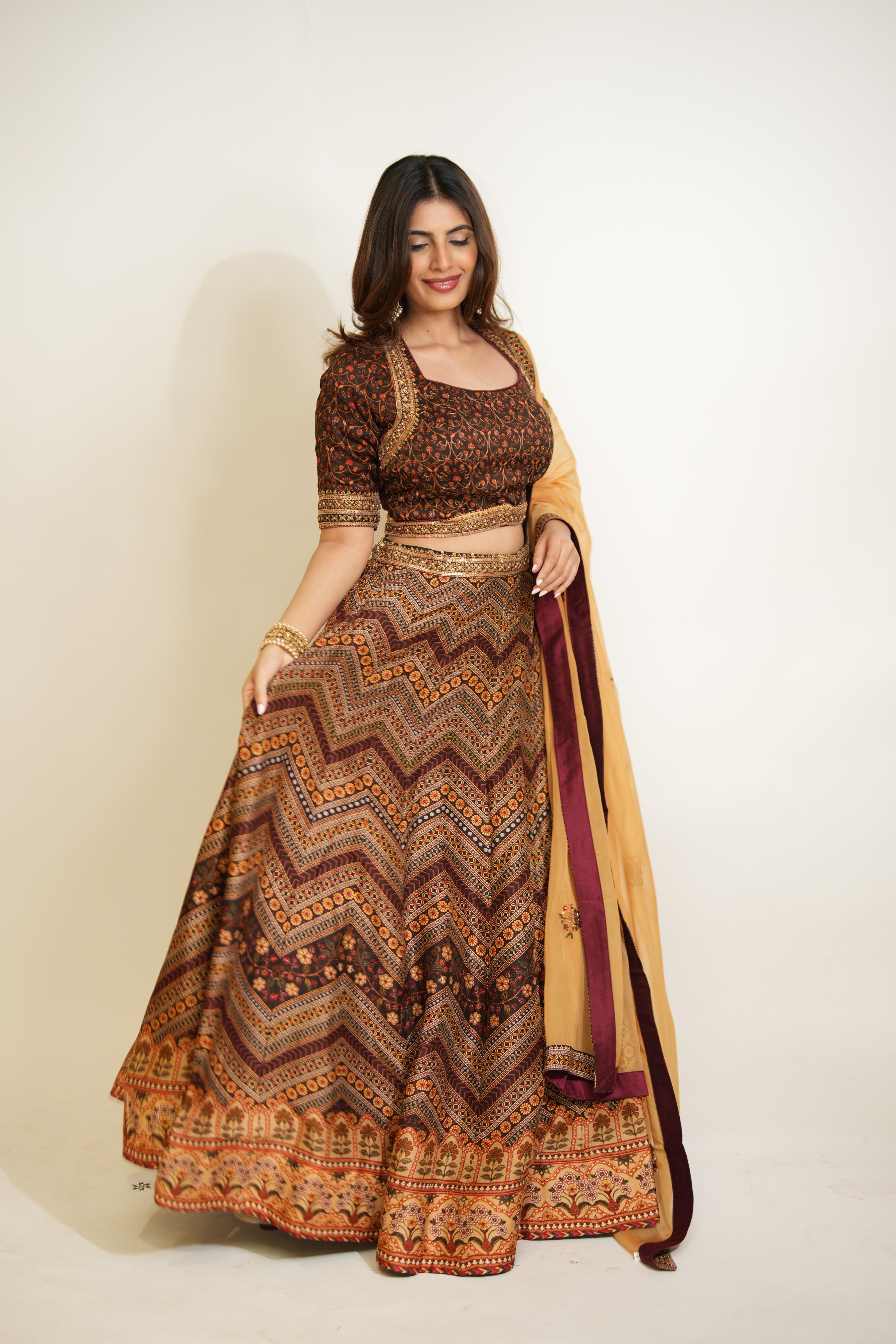 Woman wearing a patterned traditional outfit with a plain background