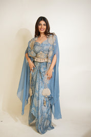 Woman wearing a blue patterned outfit with a matching shawl on a white background