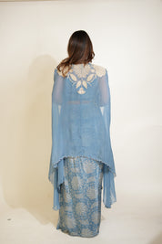 Woman wearing a blue lace outfit with a white background