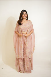 Woman wearing a pink traditional outfit with a white background